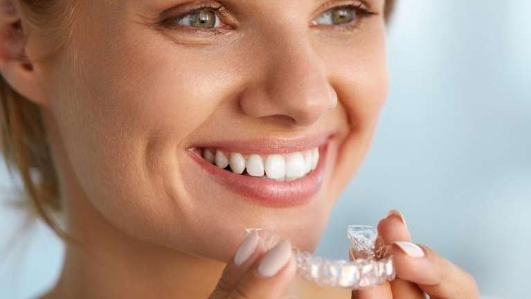 Invisalign Boise | Woman putting in clear aligners