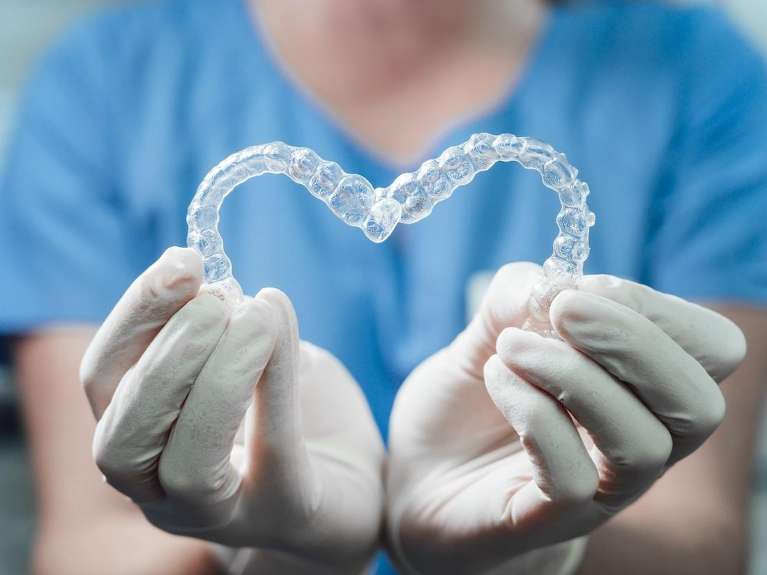 invisalign boise | dentist holding clear aligners